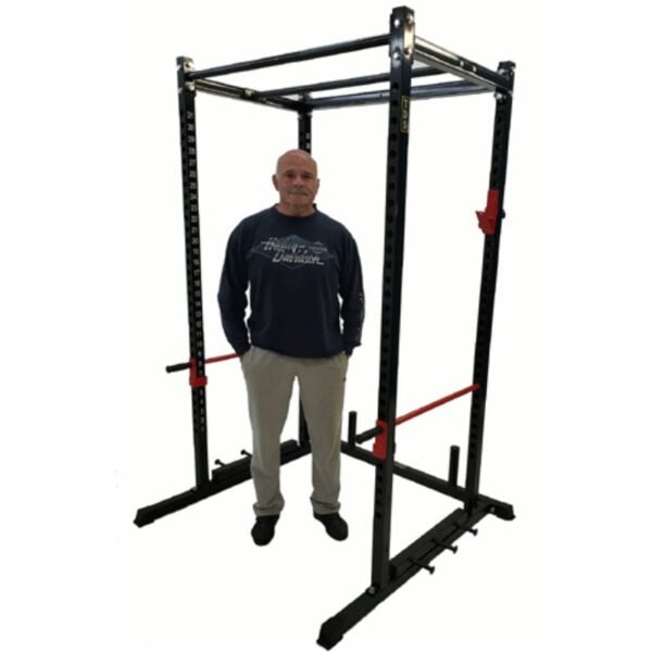 duuing standing next to black squat rack